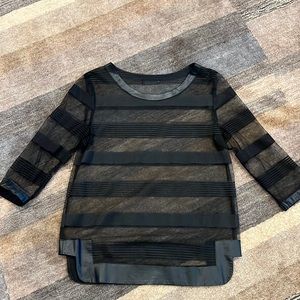 A black sheer top lined in black leather